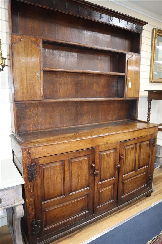 An 18th century and later panelled oak dresser, with boarded rack W.171cm